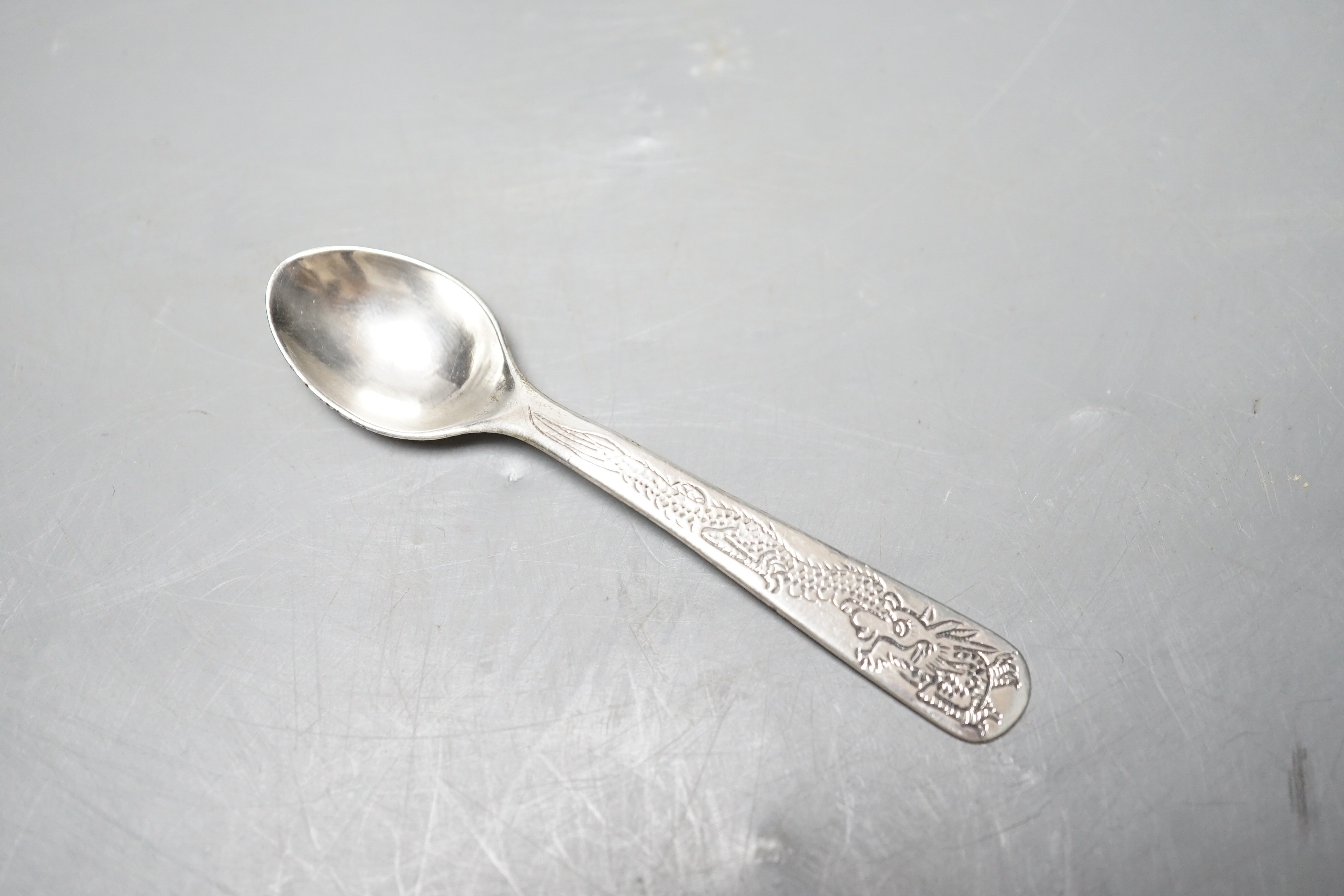 An early 20th century Chinese Export white metal dragon ‘egg’ cup and spoon, by Zee Shun, cup 76mm.